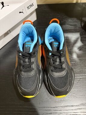 Puma Kids Black Sneakers with Blue Lining and Orange Accents
